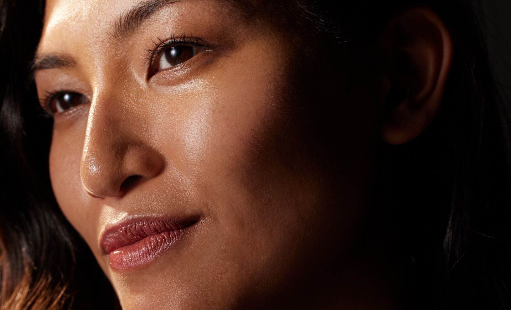 Close-up of a woman with glowing, radiant skin.