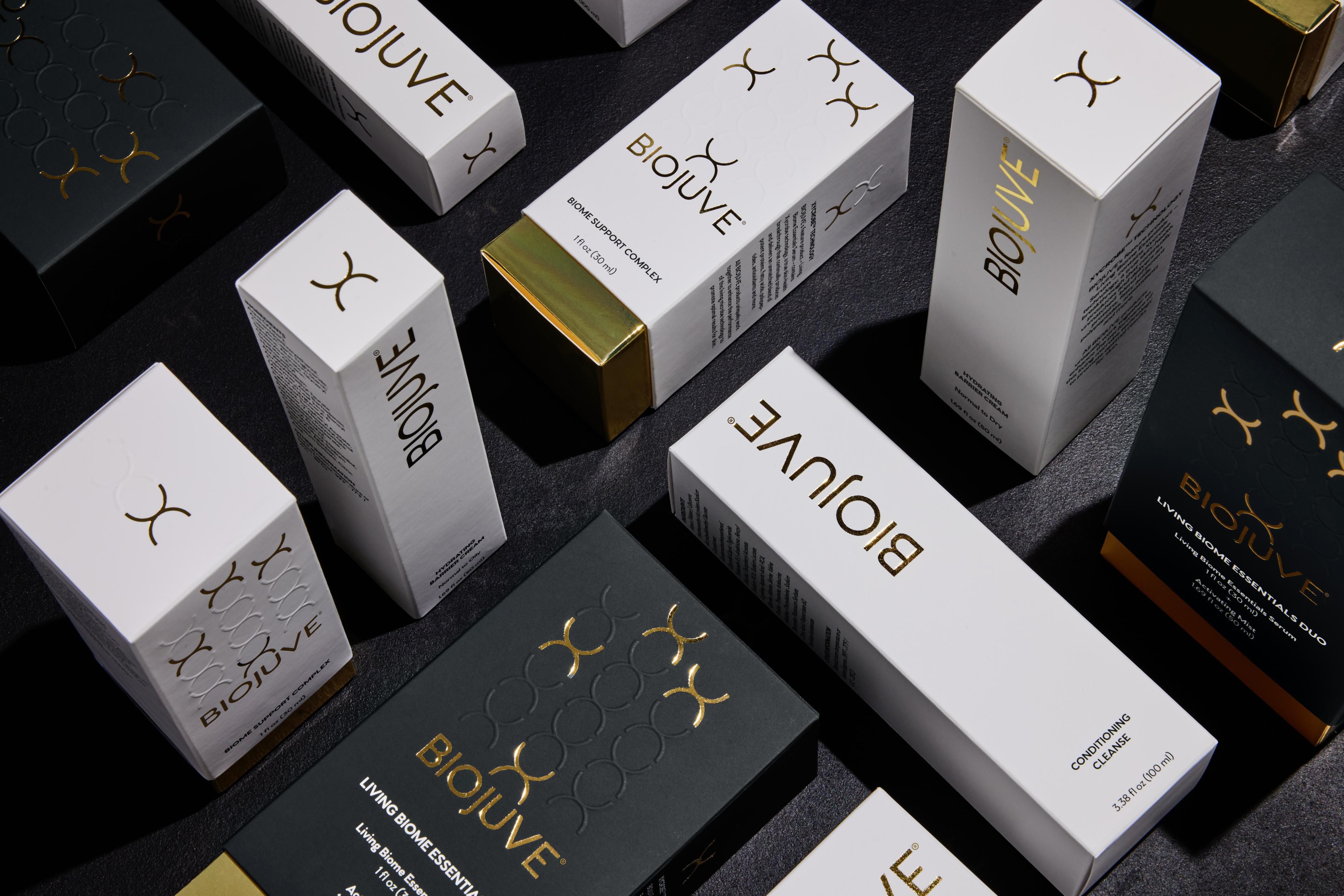 BIOJUVE product boxes arranged on a dark surface.